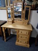 A pine dressing table fitted with three drawers and triple mirror