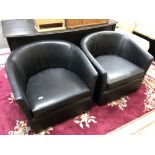 A pair of black vinyl stitched tub chairs