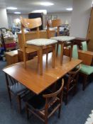 A twentieth century teak extending table and four rail backed dining chairs and further pair of