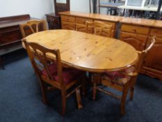 A pine drop leaf kitchen table together with four pine dining chairs