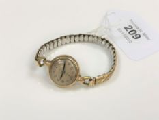 A lady's 9ct gold vintage Tudor wristwatch on plated expanding strap, lacks crown, a/f.