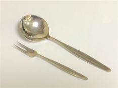 A George Jensen silver pickle fork and spoon