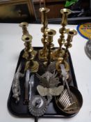 A tray of metal ware, three pairs of brass candlesticks, pheasant and gun dog figure,
