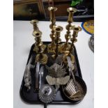 A tray of metal ware, three pairs of brass candlesticks, pheasant and gun dog figure,