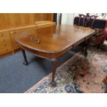 A Victorian mahogany wind out table with leaf and handle on claw & ball feet
