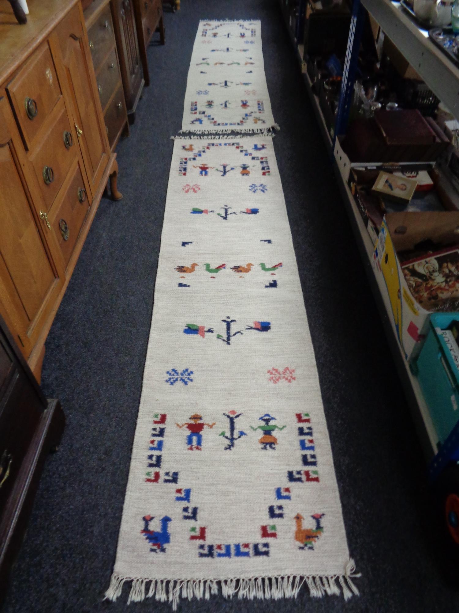 A pair of fringed flat weave runners