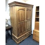 A pine double door wardrobe with two drawers