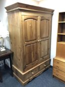 A pine double door wardrobe with two drawers