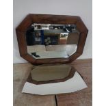 An Edwardian oak bevelled mirror together with a frameless mirror