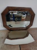 An Edwardian oak bevelled mirror together with a frameless mirror