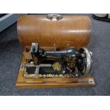 A cased vintage Triumph sewing machine