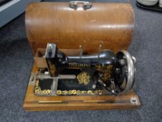 A cased vintage Triumph sewing machine