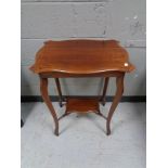 A shaped Edwardian mahogany table