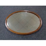 An Edwardian mahogany oval bevelled mirror