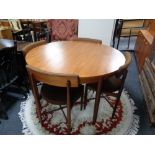 A twentieth century circular teak G-plan Fresco extending dining table and four chairs designed by