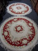 Two circular floral fringed Chinese rugs