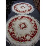 Two circular floral fringed Chinese rugs