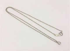 A Tiffany & Co diamond solitaire pendant on platinum chain, approximately 0.15ct.