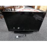 A Toshiba 32 inch LCD TV with remote (battery cover missing)