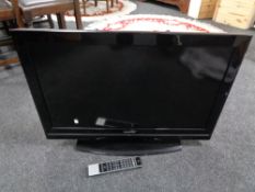 A Toshiba 32 inch LCD TV with remote (battery cover missing)