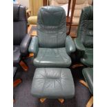 A green leather swivel relaxer chair with stool