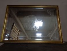 A gilt framed etched mirror depicting a Romany horse drawn caravan