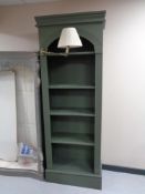 A set of tall painted shelves fitted with reading light