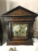 An Edwardian carved pine cased bracket clock with brass and enamelled dial