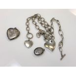 Two silver chains strung with hearts, together with two engraved silver lockets.