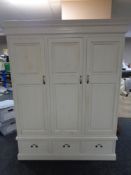 A Barker and Storehouse painted triple door wardrobe fitted with three drawers