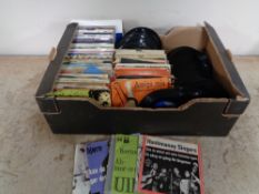 A box of vinyl 45's and singles