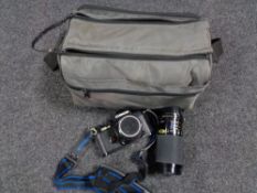 A camera bag containing a Chinon CE-4 camera with lens and accessories