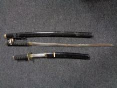 A Japanese style Katana in sheath with matching short sword