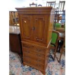 An inlaid yewwood cocktail cabinet fitted with slide and four drawers