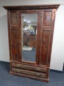 An Edwardian pine mirror door wardrobe