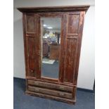 An Edwardian pine mirror door wardrobe