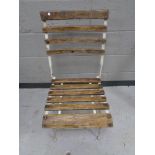 A folding metal wooden slatted garden chair