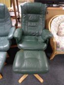 A green leather swivel relaxer chair with stool