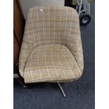 A twentieth century swivel chair upholstered in brown and beige fabric on chrome swivel base