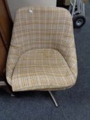 A twentieth century swivel chair upholstered in brown and beige fabric on chrome swivel base