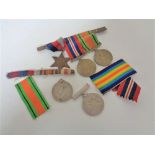 A group of three WWII medals on bar together with two further medals of the same war.