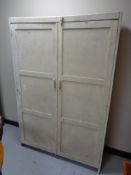 An antique pine double door cabinet