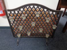 A metal beaded fire screen with eleven light holders