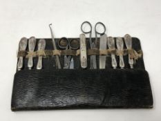 An eleven piece manicure set including seven silver mounted items knife etc