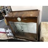 A walnut display cabinet fitted with a Smith's clock