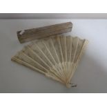 A vintage carved bone hand fan in box