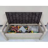 A Keta storage garden bench containing hand tools, power tools,