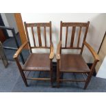 A pair of Edwardian oak carver armchairs