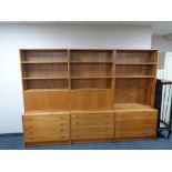 A three piece twentieth century teak bureau bookcase fitted with drawers