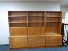 A three piece twentieth century teak bureau bookcase fitted with drawers